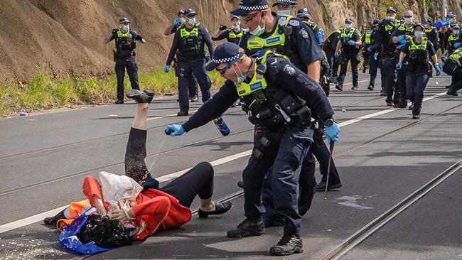 A woman is hit with pepper spray. Picture: Jason Edwards