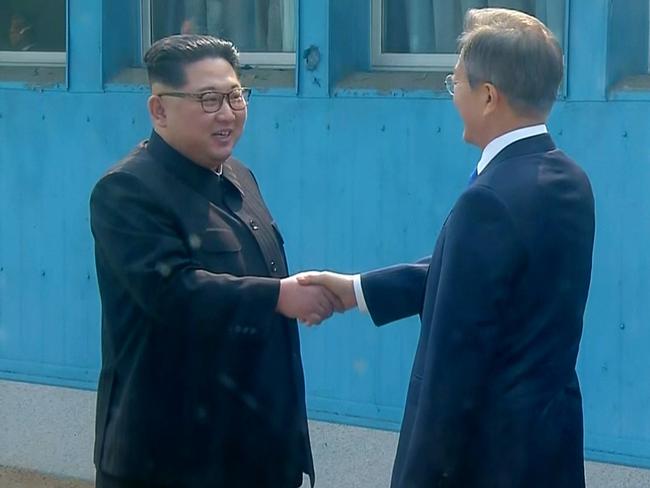 The two leaders shake hands as Kim crossed the border into South Korea. Picture: Korea Broadcasting System/AP