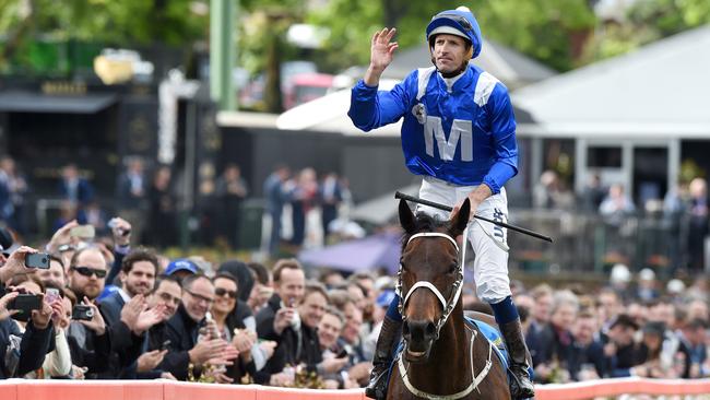 Hugh Bowman celebrates after riding Winx to the line to win the 2016 Cox Plate. Picture: Nicole Garmston