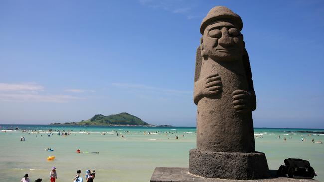 A Jeju beach with a 'grandfather' statue.