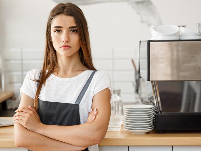 Coffee Business owner Concept - attractive young beautiful caucasian barista in apron with confident looking at camera in coffee shop counter.