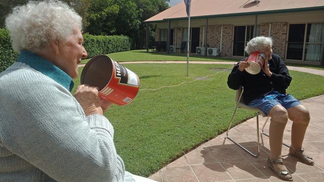 FUN TIMES REVISITED: Regis Maroochydore residents Norma Rogers and Rita Williams, enjoying the sunshine and reminiscing, while still keeping in mind social distancing.