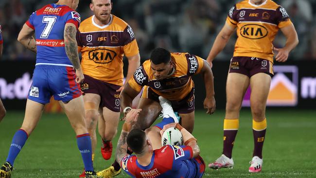 Tevita Pangai Junior puts a huge shot on Knights enforcer David Klemmer. Picture: Getty Images.