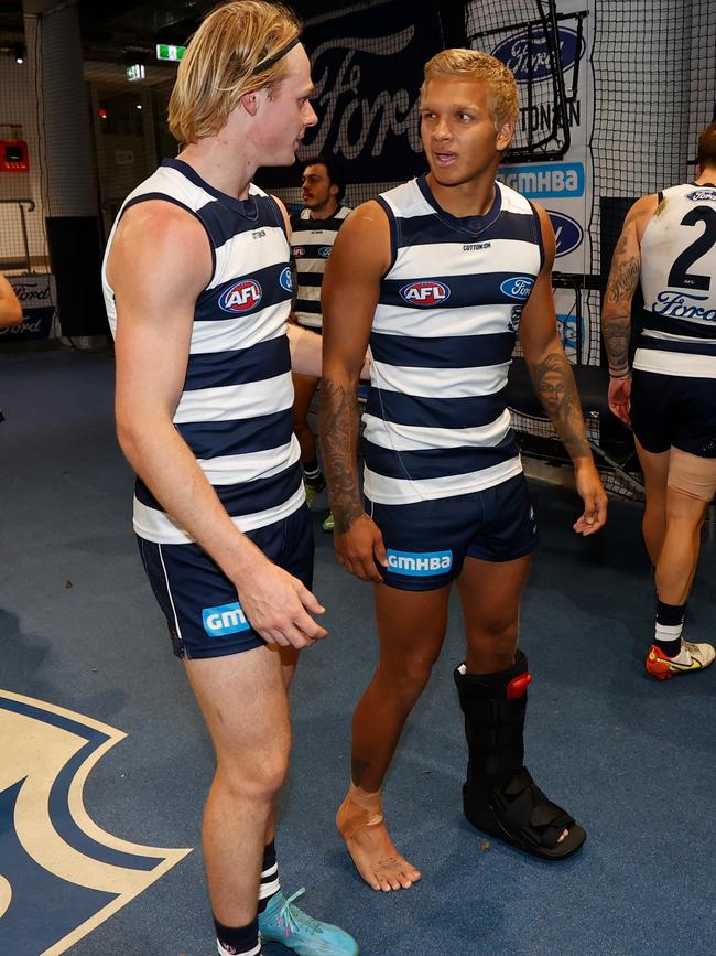 Narkle sports a moon boot as he chats to Zach Guthrie. Picture: Michael Willson/AFL Photos via Getty Images