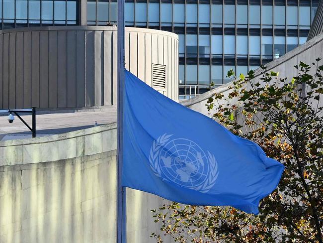 Flags fly at half-mast at the United Nations headquarters in New York on November 13, 2023 as staff observe a minute's silence in memory of colleagues killed in Gaza during the Israel-Hamas conflict. The UN agency for supporting Palestinians (UNRWA) announced on November 10 that more than 100 of its employees had died in the Gaza Strip since the start of the war. (Photo by ANGELA WEISS / AFP)