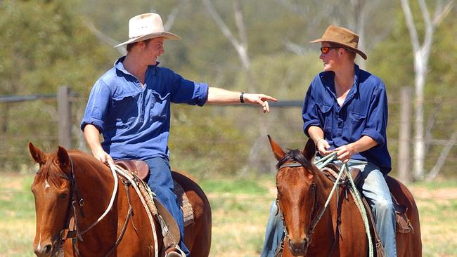 Prince Harry (right) rides with a station worker on a cattle station in outback Queensland. Picture: AAP