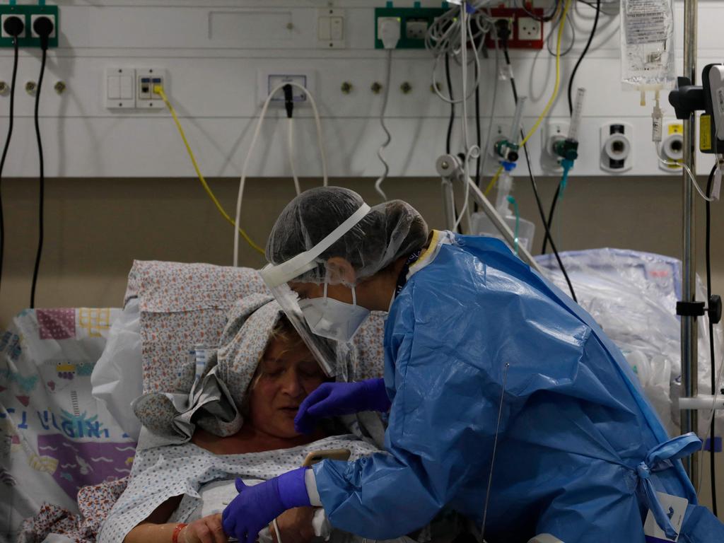 An Israeli medical worker tends to a Covid-19 patient inside a coronavirus isolation ward at the Ziv Medical Centre in northern Israel as the state confronts a surge caused by Omicron. Picture: AFP