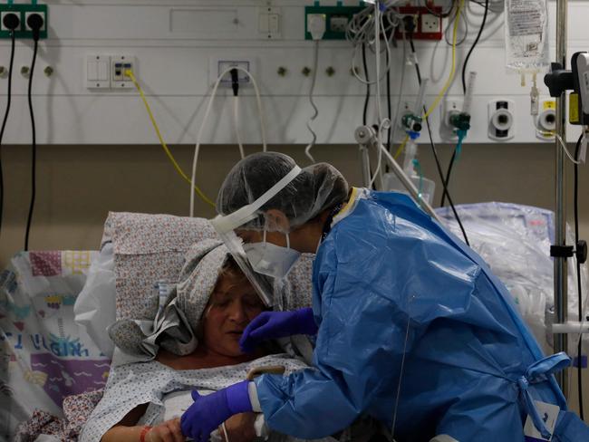 An Israeli medical worker tends to a Covid-19 patient inside a coronavirus isolation ward at the Ziv Medical Centre in northern Israel as the state confronts a surge caused by Omicron. Picture: AFP