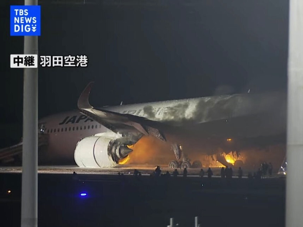 The plane was already on fire when passengers began evacuating. Picture: TBS NEWS