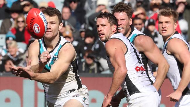 Robbie Gray of the Power handballs during the Round 22 match against Collingwood at the MCG. Picture: AAP Image/David Crosling