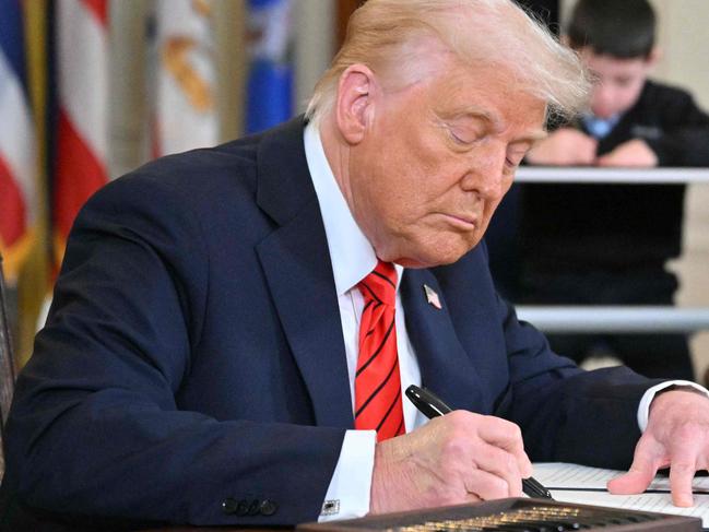 US President Donald Trump signs an executive order in the East Room of the White house in Washington, DC, March 20, 2025. US President Donald Trump will sign an order March 20, 2025 to start dismantling the Department of Education, fulfilling an election campaign pledge and a long-held dream of American conservatives. By law, the Education Department -- created in 1979 -- cannot be shuttered without the approval of Congress, and Republicans do not have the votes to push that through. (Photo by Mandel NGAN / AFP)