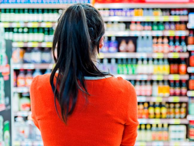 Rear view of woman doing shopping in a supermarket.