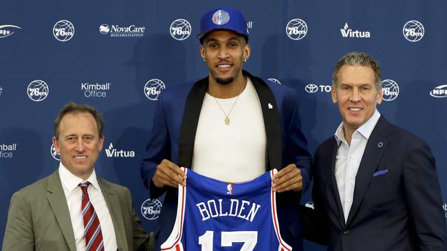 Philadelphia 76ers' draft pick Jonah Bolden, centre, poses with team president Bryan Colangelo, right, and managing owner Josh Harris.