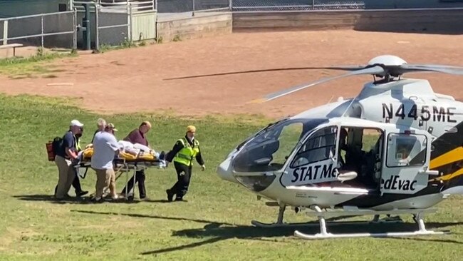 Rushdie is seen being loaded onto a medical evacuation helicopter near the Chautauqua Institution after being stabbed in the neck while speaking on stage in New York.