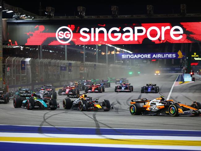 Lando Norris of the United Kingdom and McLaren Formula 1 Team, Max Verstappen of the Netherlands and Red Bull Racing-Honda RBPT, and Lewis Hamilton of the United Kingdom and Mercedes-AMG Petronas F1 Team drive on the opening lap of the F1 Grand Prix of Singapore at Marina Bay Street Circuit in Singapore, Singapore, on September 22, 2024. (Photo by Morgan Hancock/NurPhoto via Getty Images)Escape 2 Feb 2025