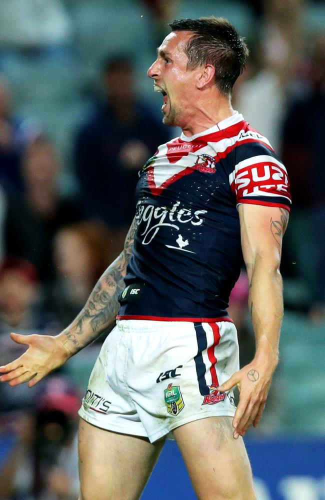 Mitchell Pearce celebrates scoring a try.