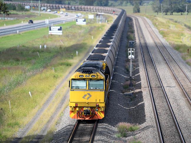 A loaded coal train is seen passing through the outskirts of Singleton, in the NSW Hunter Valley region, on Sunday, April 22, 2018. (AAP Image/Dan Himbrechts) NO ARCHIVING