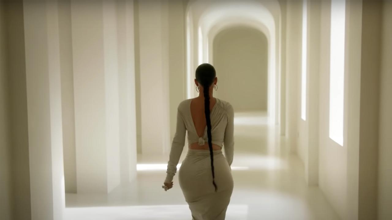 Kardashian is seen strolling through a hallway of the strikingly sparse home.