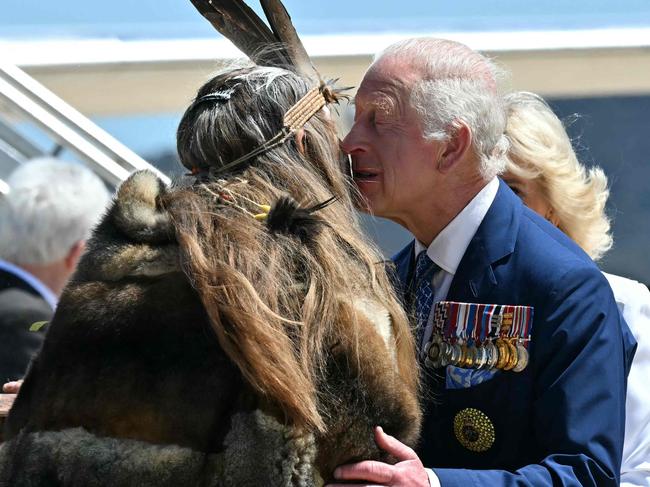 Britain's King Charles III and Queen Camilla are greeted by Ngunnawal Elder Aunty Serena Williams (2nd L) at Defence Establishment Fairbairn in Canberra on October 21, 2024, during a six-day royal visit to Sydney and Canberra. (Photo by Saeed KHAN / POOL / AFP)