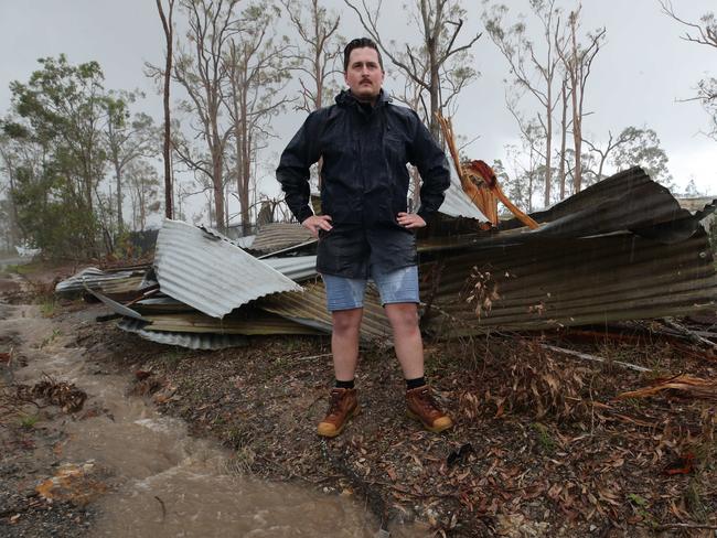 Journalist Charlton Hart keeps an eye on the storm clouds after the recent flood broke all records in the Kriedman Rd area. Picture Glenn Hampson