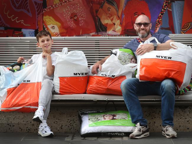 Dean Phillips and his son Leonardo snagged many bargains at the Boxing Day sales in Melbourne. Picture: David Crosling