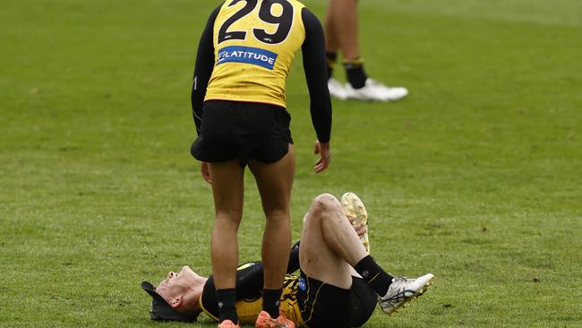 Shai Bolton inspects Noah Cumberland’s sore leg.