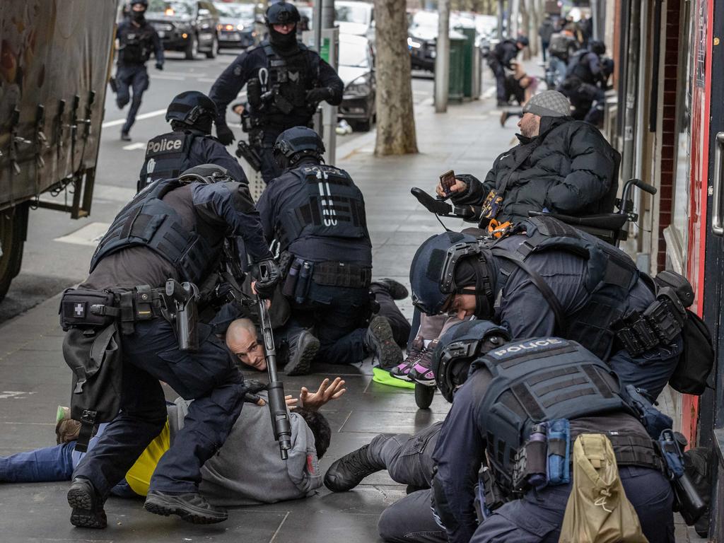 Armed specialist police arrest a group of men on Wednesday. Picture: Jason Edwards