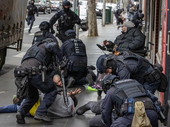 Armed specialist police arrest a group of men on Wednesday. Picture: Jason Edwards