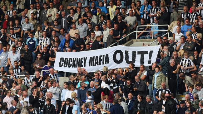 An anti-Mike Ashley banner is paraded around the pitch at St. James's Park. Photo by David Rogers/Getty Images.