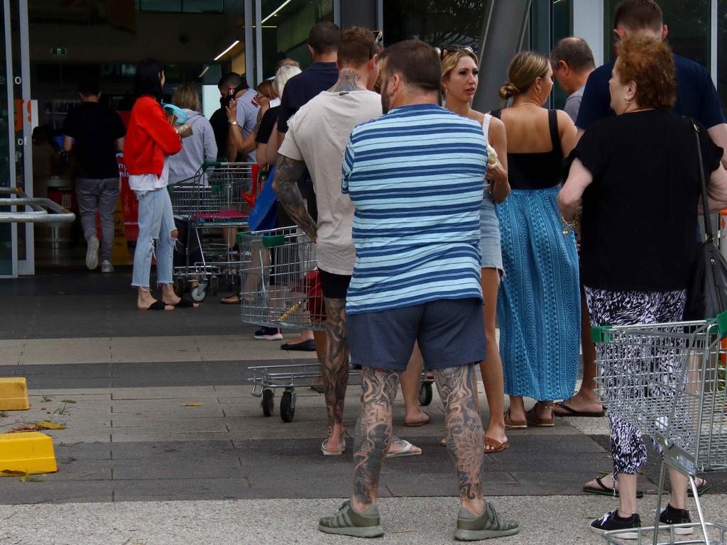 Shoppers queue at Skygate Woolworths after Premier Annastacia Palaszczuk announced a three day lockdown. Picture David Clark