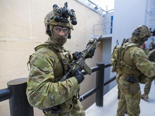 Australian Army soldiers from 2nd Commando Regiment conduct a clearance during counter-terrorism training at the Special Forces Training Facility at Holsworthy Barracks, New South Wales. *** Local Caption *** Australian Army soldiers from 2nd Commando Regiment conducted counter-terrorism training in Sydney, Melbourne and Hobart in May 2019.   The training was part of the Mars series of exercises used by the 2nd Commando Regimentâ€™s online hostage recovery/counter-terrorism company to build capacity in its role as Tactical Assault Groupâ€”East (TAGâ€“E). TAGâ€“E is the Australian Defence Forceâ€™s â€˜in extremisâ€™ online counter-terrorist force, which is designed to respond to a terrorist incident or to support state/territory police.   The commandos successfully assaulted a Sydney ferry in Middle Harbour during one of the counter-terrorism training scenarios. Other training activities involved conducting clearances on high-rise buildings, sporting arenas, ships, aircraft and other types of transport. TAGâ€“E is drawn from 2nd Commando Regiment and supplemented with Royal Australian Navy clearance divers and Special Operations Engineer Regiment combat engineers.   2nd Commando Regiment is part of the Australian Armyâ€™s Special Operations Command, which provides the Australian Government and Army with special forces capabilities in support of the national interest.