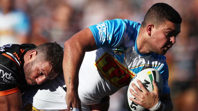 Ashley Taylor of the Titans is tackled by Robbie Farah of the Tigers during the round 16 NRL match. Photo: Getty Images