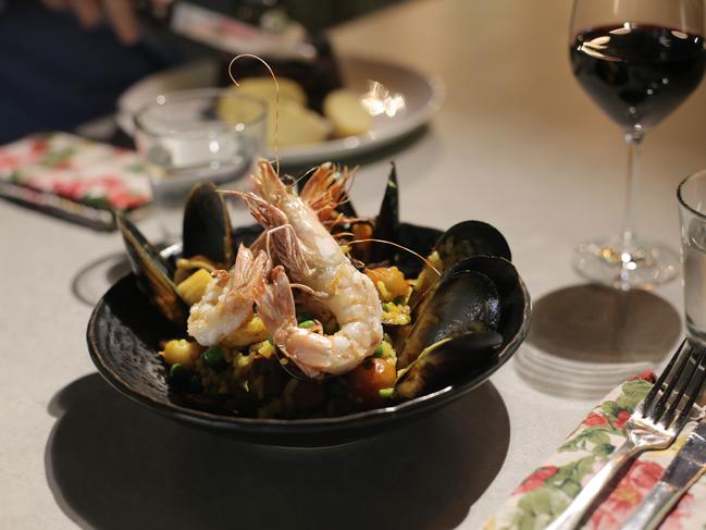 The seafood paella, shellfish and chorizo with cherry tomatoes and baby peas.