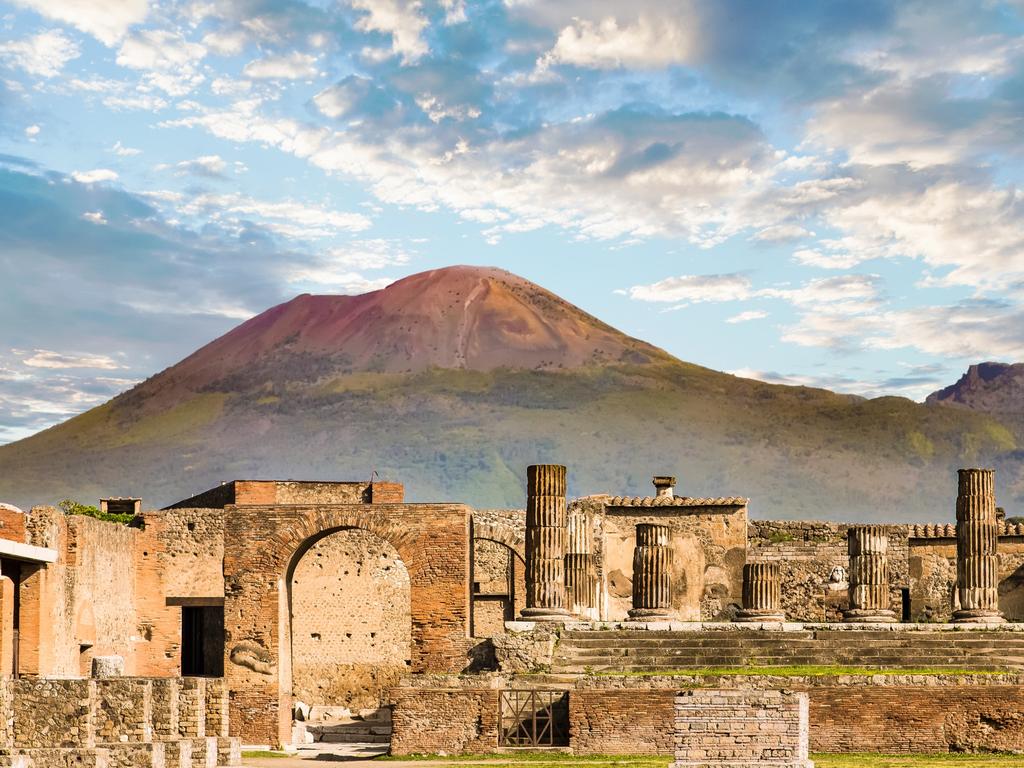 Ancient walls in Pompeii with volcano Vesuvius in the background