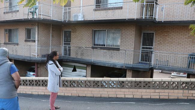 Residents inspect the fire damage in Highgate Hill. Picture: Peter Wallis