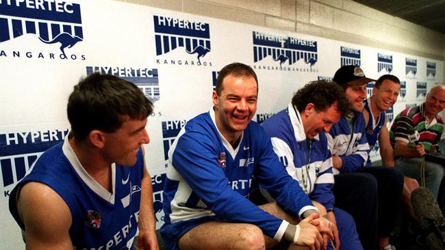 North Melbourne AFLW coach Darren Crocker (centre) in the rooms with teammates and coach Dennis Pagan (right) during the 1996 premiership season. Picture: John Feder