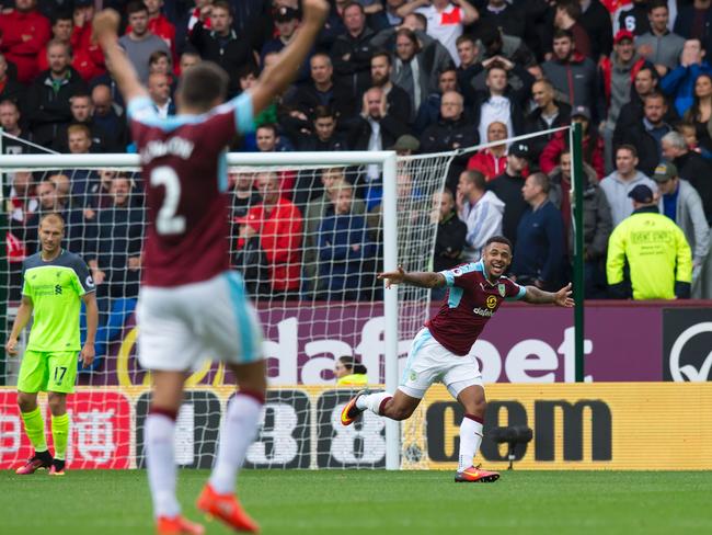 Andre Gray wheels away in delight to celebrate scoring against Liverpool.