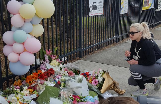 Greenacre resident Lauren Danilo, 23, visits Banksia Road Public School to pay her respects following the tragic car accident.