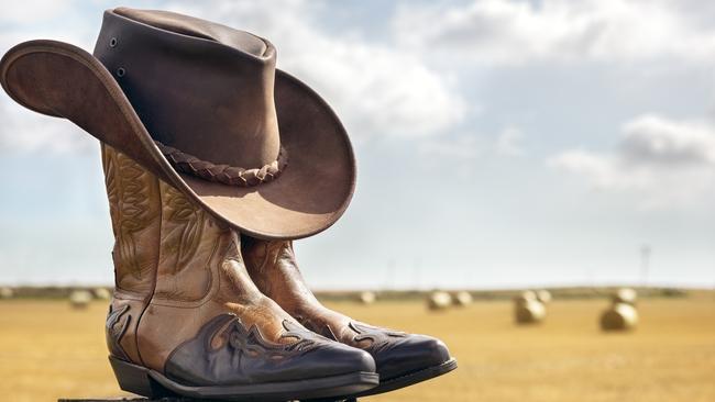 Cowboy boots and hat at ranch, country music festival live concert or line dancing concept