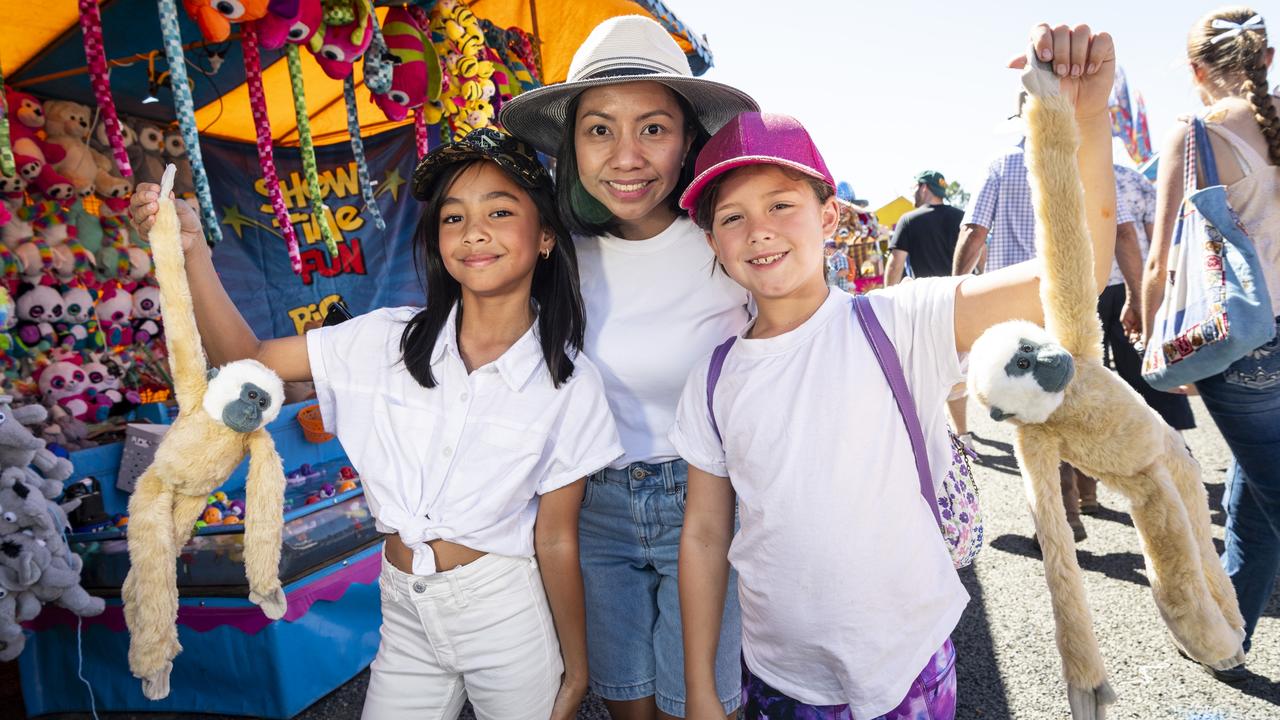 Miranda Cabahug (left) and Lilly Porter, with Mel Cabahug, show the soft toys won at sideshow alley Toowoomba Royal Show, Friday, April 19, 2024. Picture: Kevin Farmer