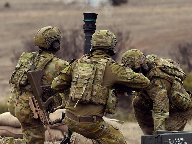 (FILES) A file photo taken on May 9, 2019 shows Australian Army soldiers firing an 81mm mortar round during Excercise Chong Ju, a live fire demonstration showcasing the army's joint combined arms capabilities, at the Puckapunyal Military Base some 100 kilometres north of Melbourne. - Australia launched its biggest defence shakeup in decades on April 24, 2023, vowing to turn a military that is "no longer fit for purpose" into a fighting force that could deter China or any would-be foe. (Photo by William WEST / AFP)