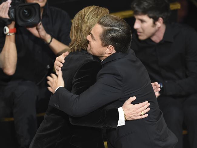 Brad Pitt, left, is congratulated by Leonardo DiCaprio at the Oscars. Picture: AP