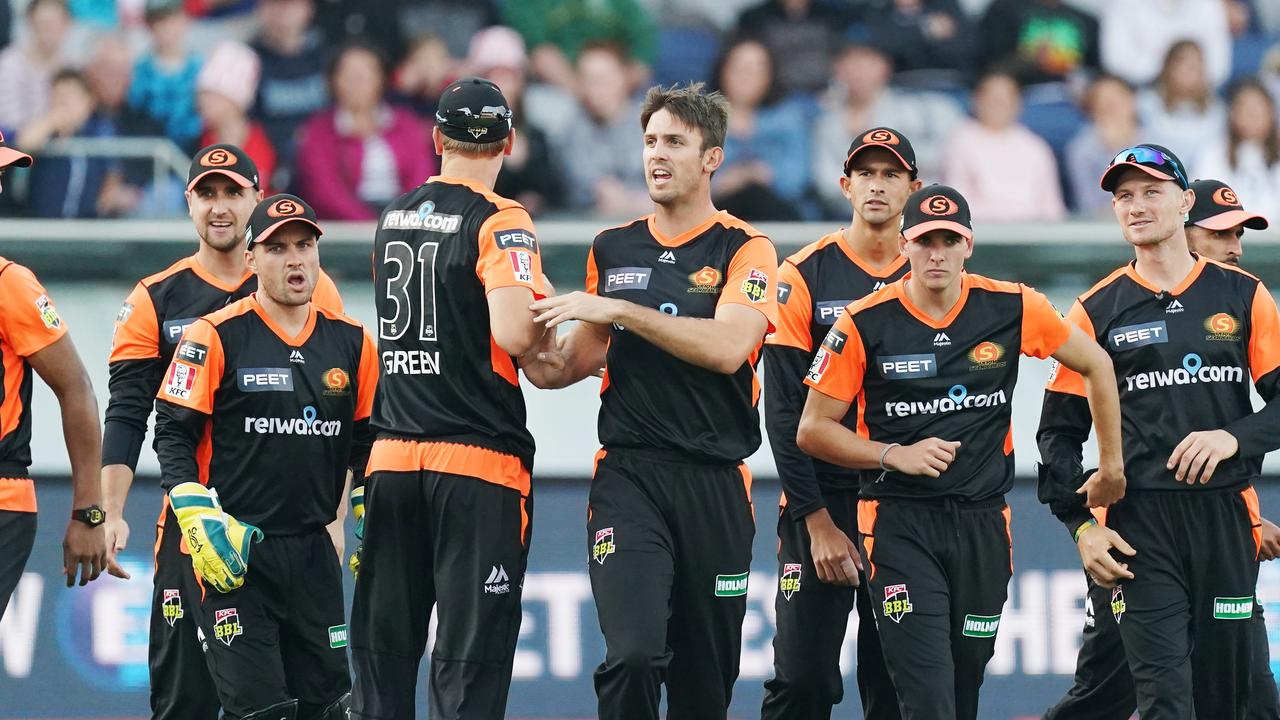 Mitch Marsh is congratulated by his teammates after taking the wicket of his brother Shaun in Geelong.