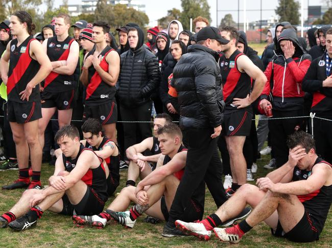 Eltham coach Paul King comforts his players on grand final day.