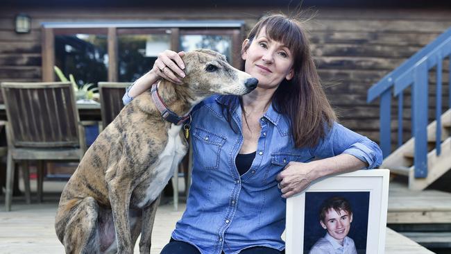 Kim with her son Daniel's dog Bella and a photo of the teen, who died in 2018. Picture: Alan Barber