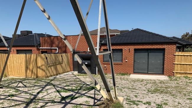 A giant electrical tower stands over a newly built unit block in Clarinda.