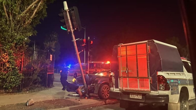 A blue Commodore has crashed into a traffic light in Alice Springs in the early hours of Friday morning. Picture: Supplied/Action for Alice 2020