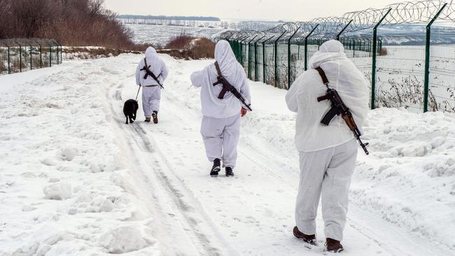 Ukrainian frontier guards walk along the border with Russia, 40 km from the second largest Ukrainian city of Kharkiv, on February 16. Picture: Sergey Bobok/AFP