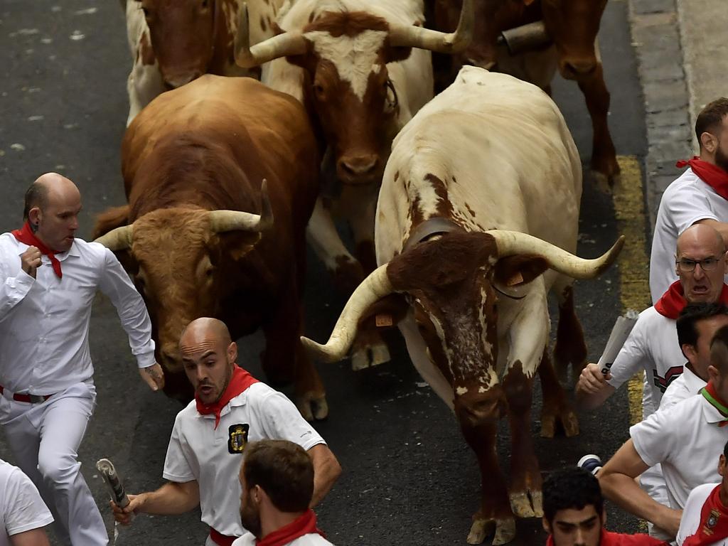 People try to evade the fighting bulls. Picture: AP