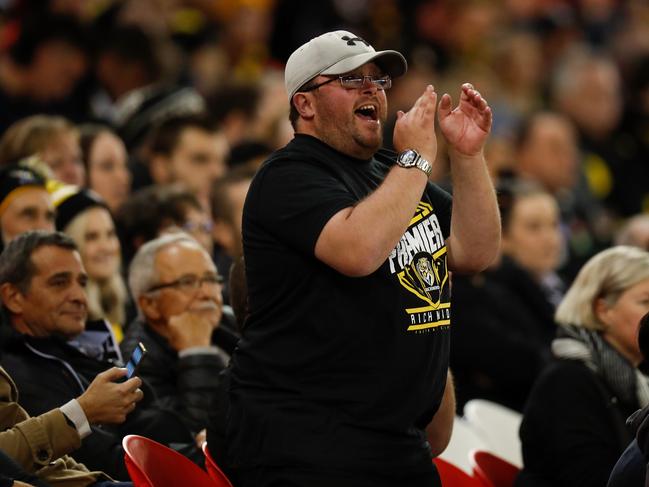 MELBOURNE, AUSTRALIA - MARCH 05: A Tigers fan cheers during the 2021 AAMI Community Series match between the Collingwood Magpies and the Richmond Tigers at Marvel Stadium on March 5, 2021 in Melbourne, Australia. (Photo by Michael Willson/AFL Photos via Getty Images)